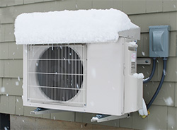 Heat pump outdoor unit covered in snow